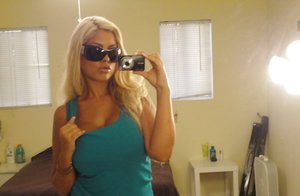 18 year old female Doris G slips off her underwear to pose naked on her bed